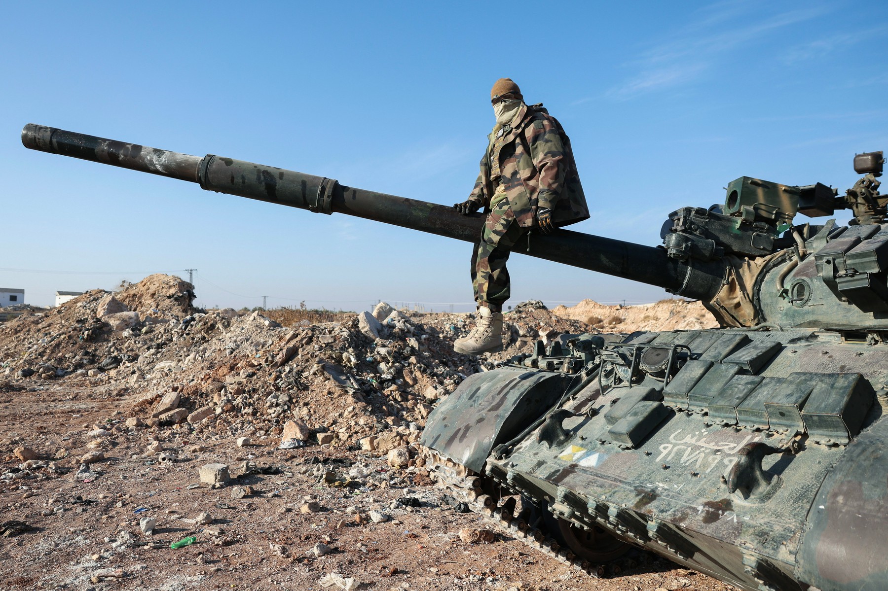 A militant poses for a picture after anti-government fighters seized Syrian army military equipment and vehicles that were abandoned on the highway to Damascus, as they reach the town of Suran north of Syria's Hama city on December 3, 2024. Islamist-led rebels advanced on Syria's fourth-largest city Hama on December 3, buoyed by their lightning capture of swathes of the north in an offensive that ended four years of relative calm.,Image: 942422650, License: Rights-managed, Restrictions: , Model Release: no, Credit line: Omar HAJ KADOUR / AFP / Profimedia