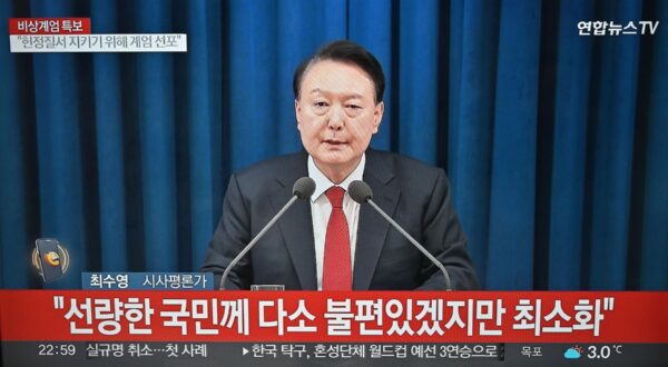 A television screen shows South Korea's President Yoon Suk Yeol speaking during a news broadcast in Goyang, northwest of Seoul on December 3, 2024, after he declared emergency martial law, saying the step was necessary to protect the country from 