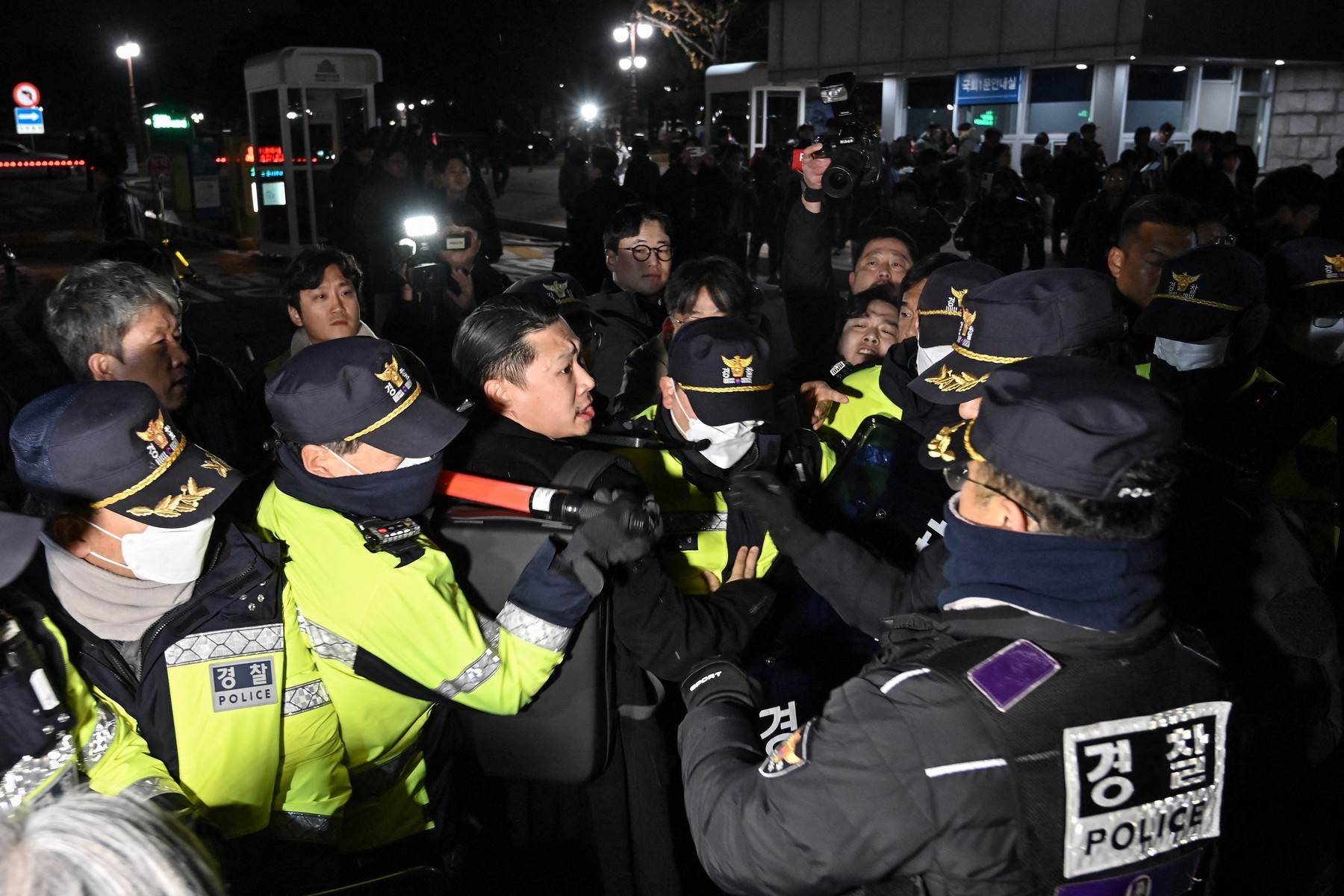 Police attempt to hold back people trying to enter the National Assembly in front of the main gate of the National Assembly in Seoul, South Korea on December 3, 2024, after President Yoon Suk Yeol declared emergency martial law.  South Korea's President Yoon Suk Yeol on December 3 declared emergency martial law, saying the step was necessary to protect the country from "communist forces" amid parliamentary wrangling over a budget bill.,Image: 942460693, License: Rights-managed, Restrictions: , Model Release: no, Credit line: JUNG YEON-JE / AFP / Profimedia