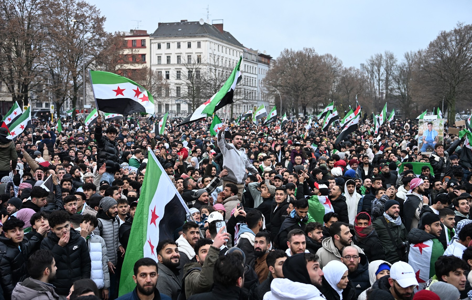 Members of the Syrian community wave Syrian flags as they attend a rally on December 8, 2024 in Berlin, Germany, to celebrate the end of Syrian dictator Bashar al-Assad's rule after rebel fighters took control of the Syrian capital Damascus overnight. Islamist-led rebels toppled Syria's longtime ruler Bashar al-Assad in a lightning offensive that a UN envoy called "a watershed moment" for the nation marred by civil war.,Image: 944384267, License: Rights-managed, Restrictions: , Model Release: no, Credit line: RALF HIRSCHBERGER / AFP / Profimedia