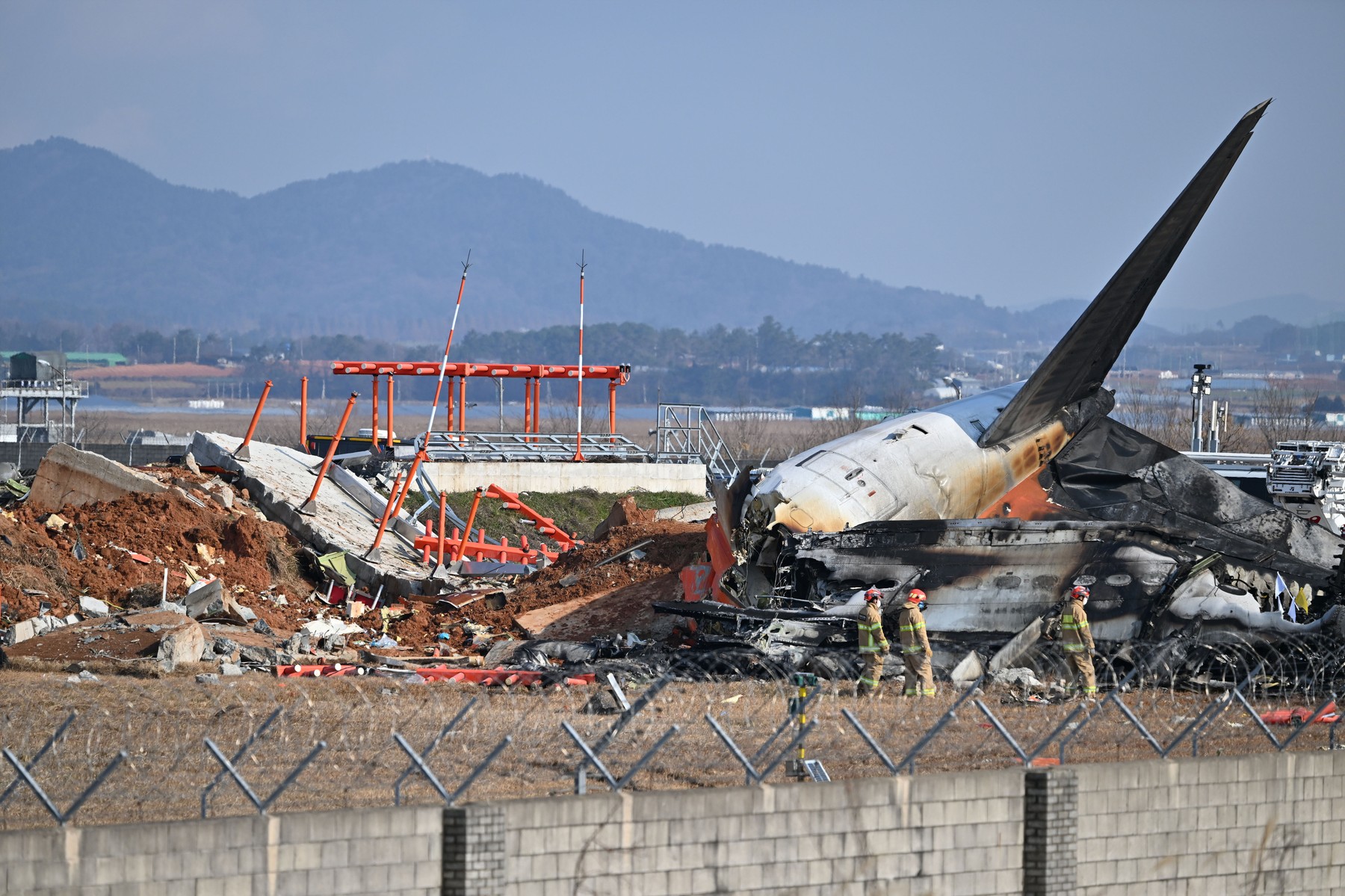 SEOUL, Dec. 29, 2024  -- This photo shows the site of an airplane crash at the Muan International Airport, some 290 km southwest of Seoul, South Korea, Dec. 29, 2024.
  Most of the people aboard a South Korean airplane that crashed at an airport in southwest South Korea on Sunday morning were believed to have been killed except two rescued, local fire authorities said.
  The passenger plane with 175 passengers, including 173 South Koreans and two Thais, as well as six flight attendants on board, crashed while attempting to land at the Muan International Airport, some 290 km southwest of the capital Seoul, at about 9:07 a.m. local time (0007 GMT).,Image: 950672894, License: Rights-managed, Restrictions: , Model Release: no, Credit line: NEWSIS / Xinhua News / Profimedia