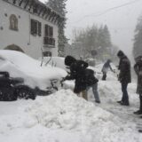 epa11764613 People walk during a snowfall in Canfranc, Huesca, Spain, 08 December 2024.  EPA/JAVIER BLASCO