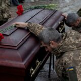 Ukrainian army members mourn next to the coffin of Pavlo Vedybida, callsign 