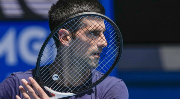 Defending men's champion Serbia's Novak Djokovic practices on Rod Laver Arena ahead of the Australian Open tennis championship in Melbourne, Australia, Wednesday, Jan. 12, 2022. AP Photo/Mark Baker)