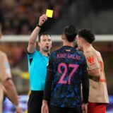 Referee Felix Zwayer shows a yellow card to Sevilla's Kike Salas during the Champions League Group B soccer match between Lens and Sevilla at the Bollaert stadium in Lens, France, Tuesday, Dec. 12, 2023. (AP Photo/Thibault Camus) France Soccer Champions League