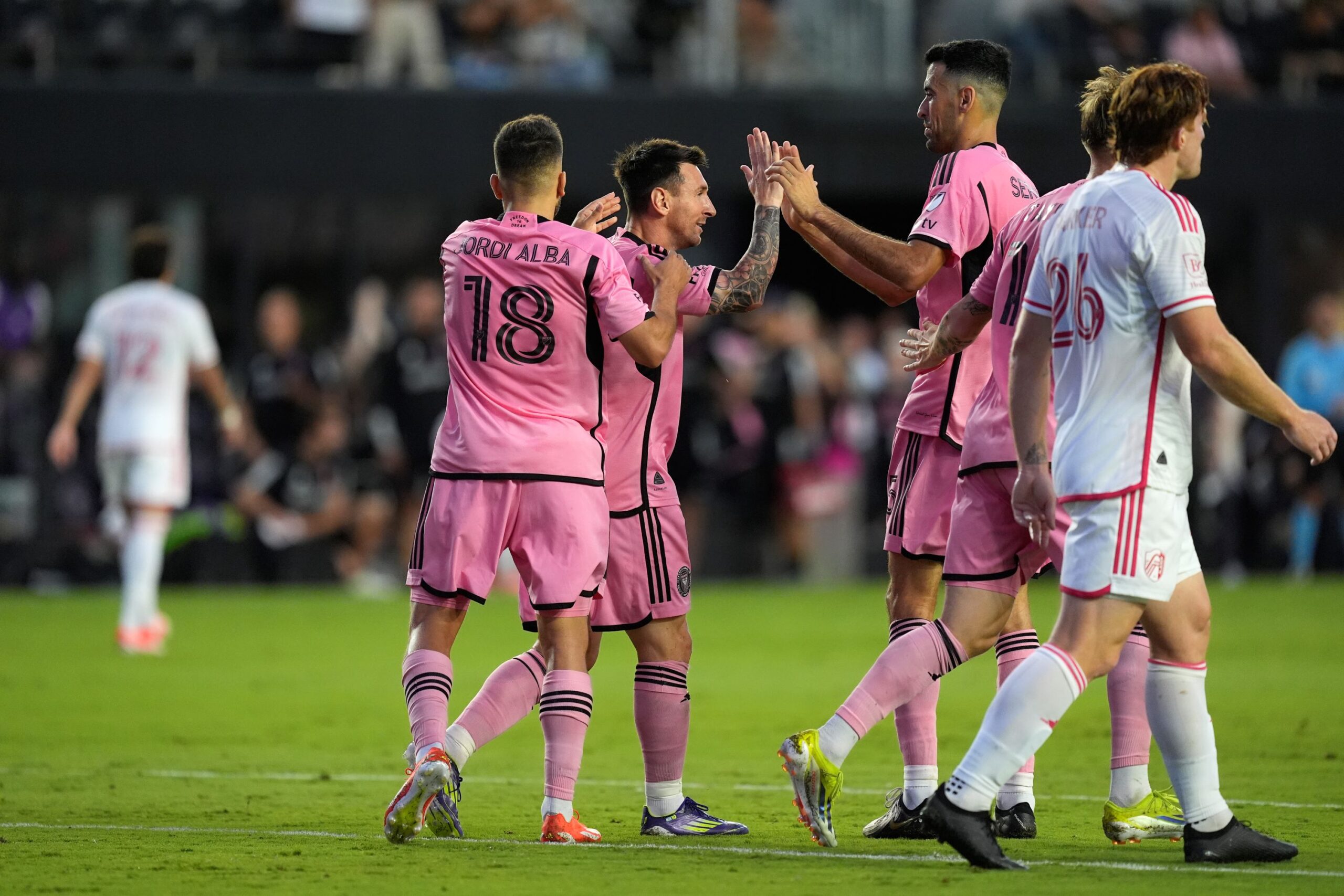 Inter Miami forward Lionel Messi, second from left, celebrates his goal against St. Louis City with defender Jordi Alba (18) and midfielder Sergio Busquets during the first half of an MLS soccer match Saturday, June 1, 2024, in Fort Lauderdale, Fla. (AP Photo/Rebecca Blackwell) MLS St Louis Inter Miami Soccer