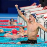 Leon Marchand, of France, celebrates after winning the men's 400-meter individual medley final at the 2024 Summer Olympics, Sunday, July 28, 2024, in Nanterre, France.(AP Photo/Martin Meissner) APTOPIX Paris Olympics Swimming