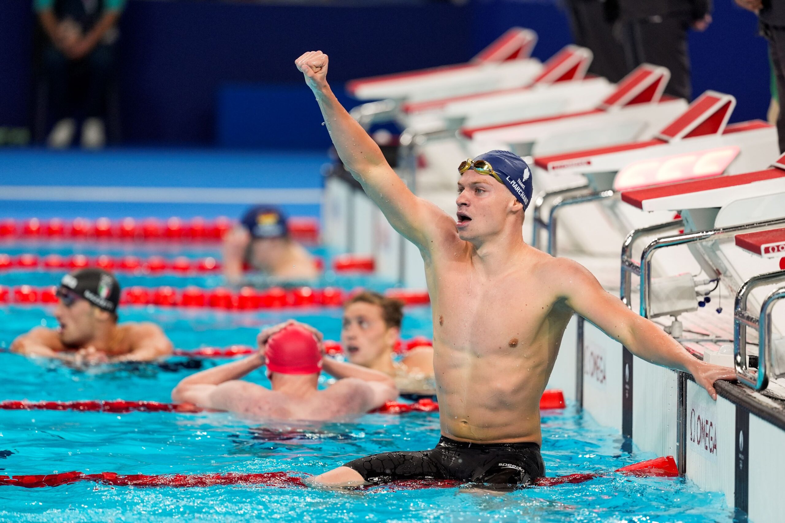 Leon Marchand, of France, celebrates after winning the men's 400-meter individual medley final at the 2024 Summer Olympics, Sunday, July 28, 2024, in Nanterre, France.(AP Photo/Martin Meissner) APTOPIX Paris Olympics Swimming