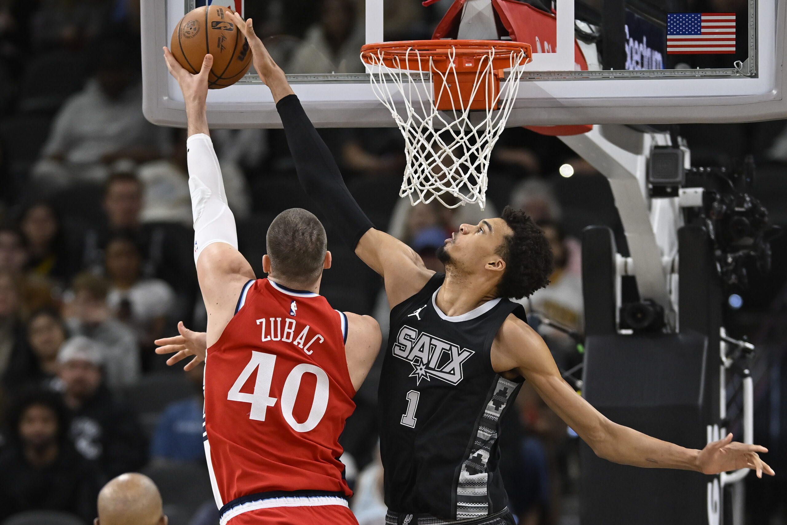 San Antonio Spurs' Victor Wembanyama (1) blocks a shot by Los Angeles Clippers' Ivica Zubac during the first half of an NBA basketball game, Tuesday, Dec. 31, 2024, in San Antonio. (AP Photo/Darren Abate)