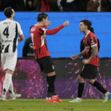 AC Milan's Alvaro Morata, left, and Christian Pulisic celebrate after scoring during the Italian Super Cup semifinal soccer match between Juventus and Milan in Riyadh, Saudi Arabia, Friday, Jan. 3, 2025. (AP Photo/Altaf Qadri)