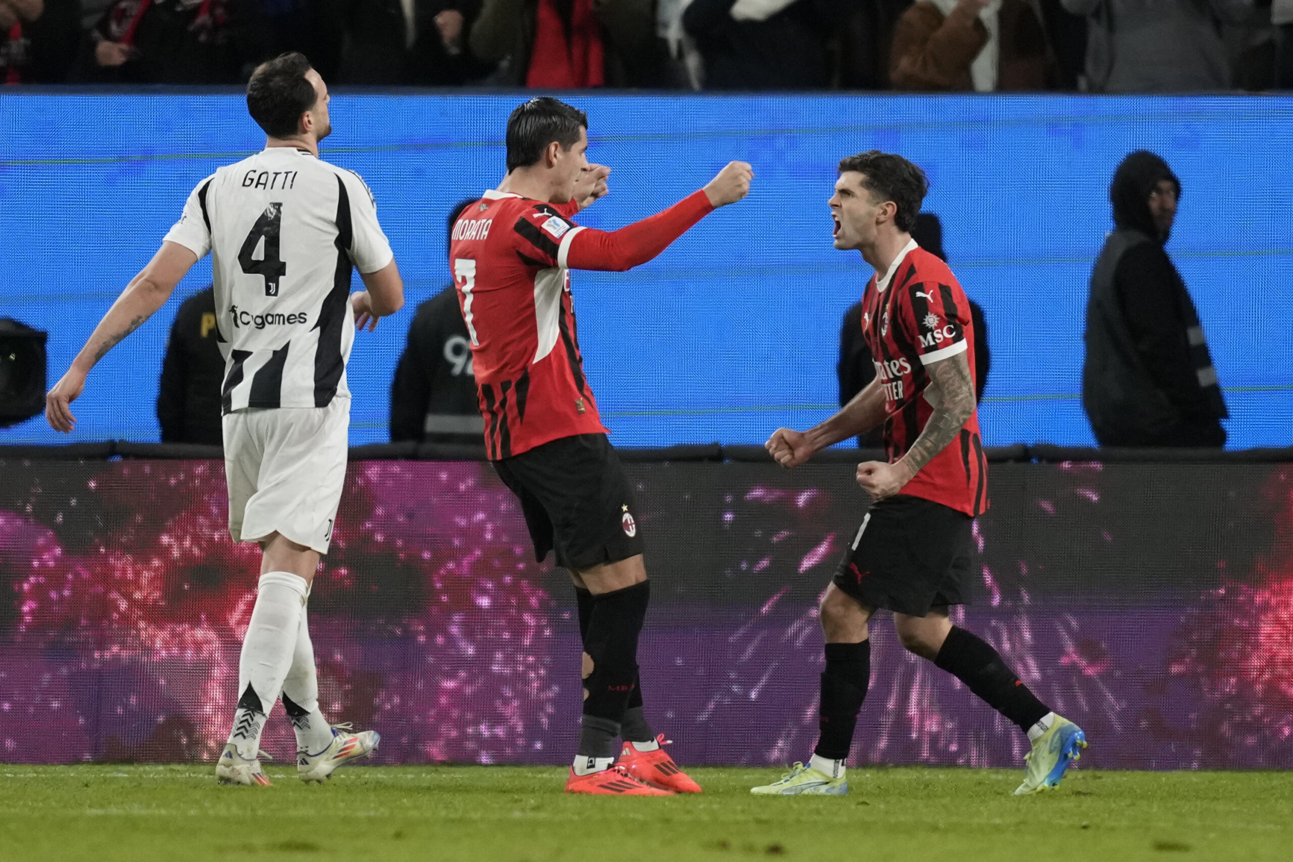 AC Milan's Alvaro Morata, left, and Christian Pulisic celebrate after scoring during the Italian Super Cup semifinal soccer match between Juventus and Milan in Riyadh, Saudi Arabia, Friday, Jan. 3, 2025. (AP Photo/Altaf Qadri)