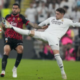 Real Madrid's Federico Valverde, right, is challenged by Mallorca's Omar Mascarell during the Spanish Super Cup semifinal soccer match between Real Madrid and Mallorca at the King Abdullah Stadium in Jeddah, Saudi Arabia, Thursday, Jan. 9, 2025. (AP Photo/Altaf Qadri)