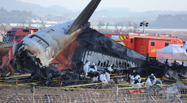 epa11799471 A police forensic team conducts an on-site investigation at the scene of the 29 December Jeju Air passenger plane crash at Muan International Airport in Muan, South Korea, 31 December 2024.  EPA/YONHAP SOUTH KOREA OUT