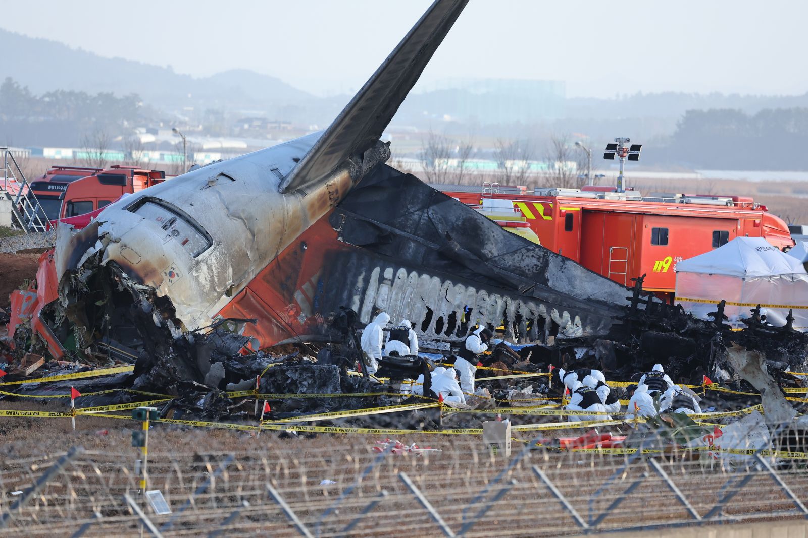 epa11799471 A police forensic team conducts an on-site investigation at the scene of the 29 December Jeju Air passenger plane crash at Muan International Airport in Muan, South Korea, 31 December 2024.  EPA/YONHAP SOUTH KOREA OUT