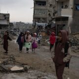 epa11799809 Palestinian children walk past their destroyed homes during heavy rains in Khan Yunis camp in the southern Gaza Strip, 31 December, 2024. According to the UN, at least 1.9 million people (or nine in ten people) across the Gaza Strip are internally displaced, including people who have been repeatedly displaced. Since October 2023, only about 11 percent of the Gaza Strip has not been placed under Israeli-issued evacuation orders, the UN aid coordination office OCHA said.   EPA/HAITHAM IMAD