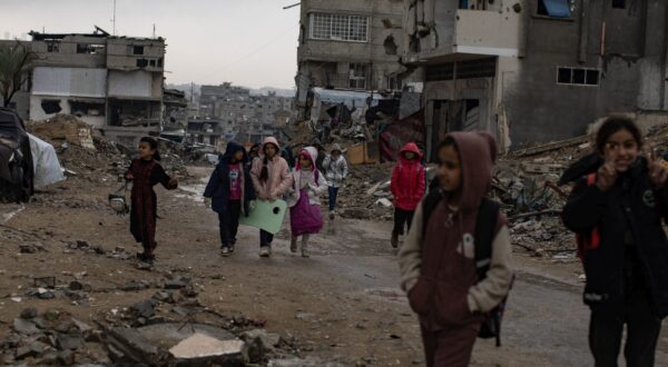 epa11799809 Palestinian children walk past their destroyed homes during heavy rains in Khan Yunis camp in the southern Gaza Strip, 31 December, 2024. According to the UN, at least 1.9 million people (or nine in ten people) across the Gaza Strip are internally displaced, including people who have been repeatedly displaced. Since October 2023, only about 11 percent of the Gaza Strip has not been placed under Israeli-issued evacuation orders, the UN aid coordination office OCHA said.   EPA/HAITHAM IMAD