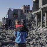 epa11803411 A Palestinian father carries his daughter next to the destroyed house of the Abu Libda family following an Israeli air strike in Al Maghazi refugee camp, central Gaza Strip, 03 January 2025. According to reports from the Ministry of Health in Gaza at least nine members of the Abu Libda family were killed following an Israeli air strike in the refugee camp. More than 45,500 Palestinians and over 1,400 Israelis have been killed, according to the Palestinian Health Ministry and the Israeli Army, since Hamas militants launched an attack against Israel from the Gaza Strip on 07 October 2023 and the Israeli operations in Gaza and the West Bank that followed it.  EPA/MOHAMMED SABER