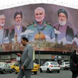 epa11808827 Iranians walk past a billboard with the pictures of late Iranian Islamic Revolutionary Guard Corps (IRGC) Quds Force commander Qasem Soleimani (C), late Hamas leaders Ismail Haniyeh (L) and Yahya Sinwar (R), and late Hezbollah leader Hasan Nasrallah (2-R), and the head of Hezbollah's executive council Hashem Safieddine (2-L), and a sentence reading in Persian 'God wrote our duty, help to the oppressed' hanging at the Enghelab square in Tehran, Iran, 06 January 2025.  EPA/ABEDIN TAHERKENAREH