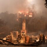 epa11813471 A house on fire and the remains of another burnt home in an area affected by the Palisades wildfire in Malibu, California, USA, 08 January 2025. According to data from California Department of Forestry and Fire Protection, CAL FIRE, the Palisades fire has burned through thousands of acres and has forced tens of thousands of evacuations in the Los Angeles area.  EPA/ALLISON DINNER