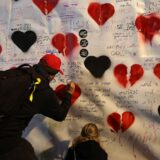 epa11834856 People write messages on a poster as families of people who were abducted during the 2023 Hamas attack in Israel rally in Tel Aviv, Israel, 18 January 2025. A ceasefire between Israel and Hamas will take effect on 19 January 2025. More than 46.000 people have been killed in Gaza since October 2023, when Israel launched a military campaign in response to a cross-border attack by Hamas, in which about 1,200 people were killed and over 200 taken hostage.  EPA/ATEF SAFADI