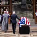 epa11815323 US President Joe Biden (C) touches the flag-draped casket of former US President Jimmy Carter before delivering remarks during Carter's State Funeral services at the National Cathedral in Washington, DC, USA, 09 January 2025. Carter, the 39th US president, died at age 100 in his hometown of Plains, Georgia, on 29 December 2024.  EPA/HAIYUN JIANG/ POOL