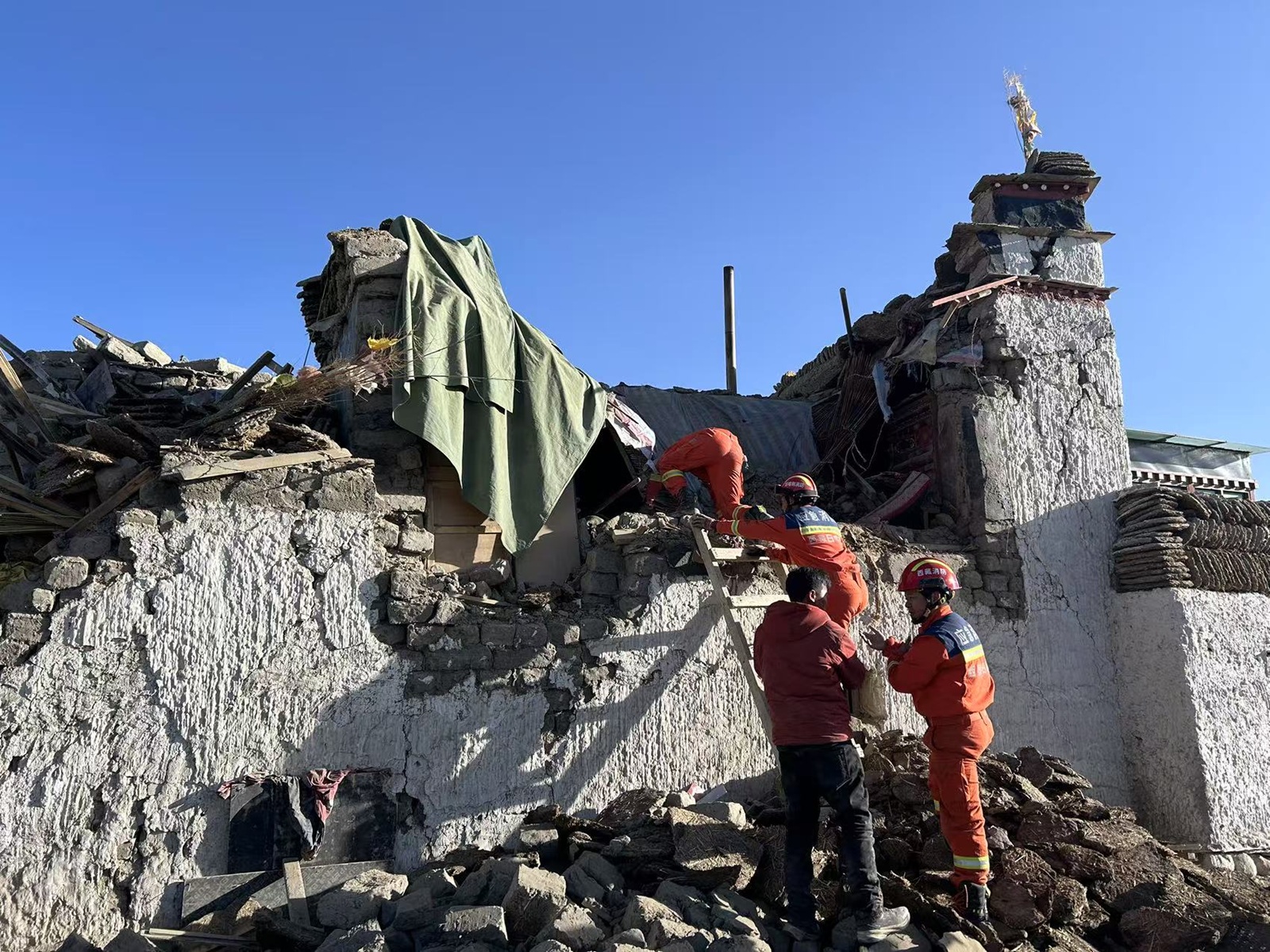 XIZANG, Jan. 7, 2025  -- Rescuers work in an earthquake-affected area in Changsuo Township of Dingri in Xigaze, southwest China's Xizang Autonomous Region, Jan. 7, 2025. Thirty-two people have been confirmed dead and 38 injured during the 6.8-magnitude earthquake that jolted Dingri County in the city of Xigaze in Xizang Autonomous Region at 9:05 a.m. Tuesday (Beijing Time), according to regional disaster relief headquarters.,Image: 952178421, License: Rights-managed, Restrictions: , Model Release: no, Credit line: Jigme Dorje / Xinhua News / Profimedia