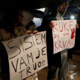 People hold placards reading "System is rotten" and "Your hands are bloody" during a protest, as government hold National Security Council after a gunman in Cetinje killed several people in a rampage, in Podgorica, Montenegro, January 3, 2025. REUTERS/Stevo Vasiljevic Photo: STEVO VASILJEVIC/REUTERS