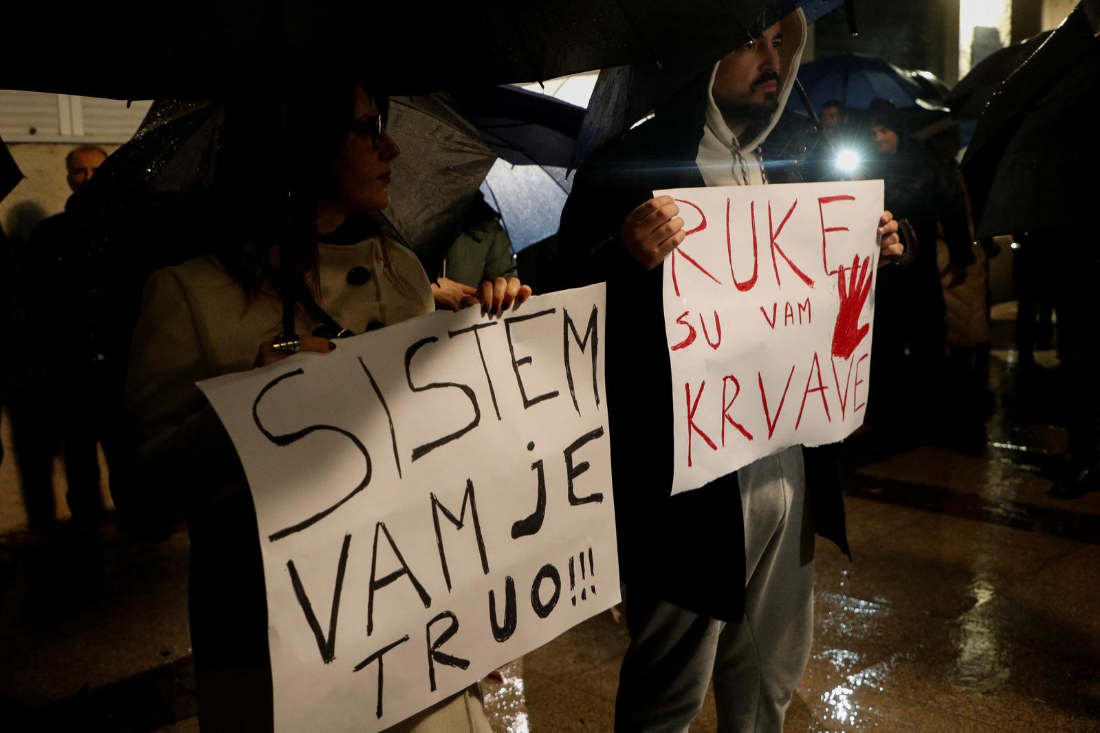 People hold placards reading "System is rotten" and "Your hands are bloody" during a protest, as government hold National Security Council after a gunman in Cetinje killed several people in a rampage, in Podgorica, Montenegro, January 3, 2025. REUTERS/Stevo Vasiljevic Photo: STEVO VASILJEVIC/REUTERS