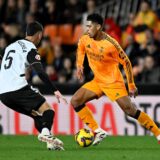 Soccer Football - LaLiga - Valencia v Real Madrid - Estadio de Mestalla, Valencia, Spain - January 3, 2025 Real Madrid's Jude Bellingham in action with Valencia's Enzo Barrenechea REUTERS/Pablo Morano Photo: Pablo Morano/REUTERS