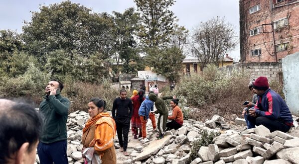 People gather in an open area following earthquake tremors in Kathmandu, in the early hours on January 7, 2025. A powerful earthquake in China's remote Tibet region killed at least 32 people and collapsed 