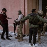 DAMASCUS, SYRIA - DECEMBER 22: Soldiers and police officers, who served in the Syrian regime army, enter the arms delivery center to surrender their weapons and ammunition with the instructions of the transitional government following the collapse of Syria's 61-year Baath regime by stepping on a table with the picture of Bashar Al Assad in Damascus, Syria on December 22, 2024. Emin Sansar / Anadolu,Image: 949284532, License: Rights-managed, Restrictions: , Model Release: no, Credit line: Emin Sansar / AFP / Profimedia