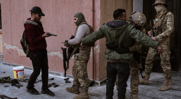 DAMASCUS, SYRIA - DECEMBER 22: Soldiers and police officers, who served in the Syrian regime army, enter the arms delivery center to surrender their weapons and ammunition with the instructions of the transitional government following the collapse of Syria's 61-year Baath regime by stepping on a table with the picture of Bashar Al Assad in Damascus, Syria on December 22, 2024. Emin Sansar / Anadolu,Image: 949284532, License: Rights-managed, Restrictions: , Model Release: no, Credit line: Emin Sansar / AFP / Profimedia