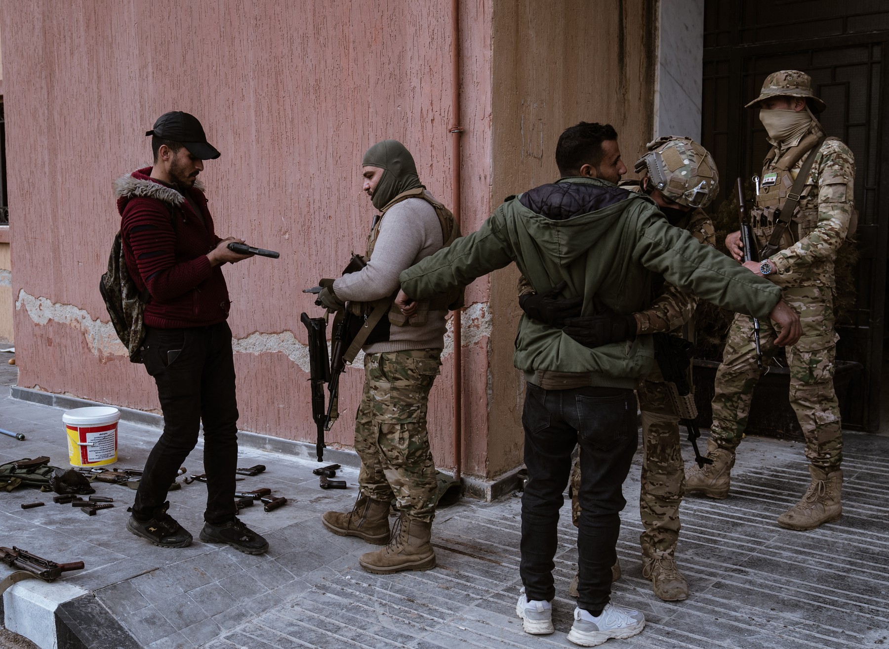 DAMASCUS, SYRIA - DECEMBER 22: Soldiers and police officers, who served in the Syrian regime army, enter the arms delivery center to surrender their weapons and ammunition with the instructions of the transitional government following the collapse of Syria's 61-year Baath regime by stepping on a table with the picture of Bashar Al Assad in Damascus, Syria on December 22, 2024. Emin Sansar / Anadolu,Image: 949284532, License: Rights-managed, Restrictions: , Model Release: no, Credit line: Emin Sansar / AFP / Profimedia