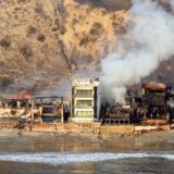 In this aerial view taken from a helicopter, burned homes are seen from above during the Palisades fire in Malibu, Los Angeles county, California on January 9, 2025.  Massive wildfires that engulfed whole neighborhoods and displaced thousands in Los Angeles remained totally uncontained January 9, 2025, authorities said, as US National Guard soldiers readied to hit the streets to help quell disorder. Swaths of the United States' second-largest city lay in ruins, with smoke blanketing the sky and an acrid smell pervading almost every building.,Image: 952681939, License: Rights-managed, Restrictions: , Model Release: no, Credit line: JOSH EDELSON / AFP / Profimedia