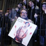 (FILES) Italian Photographer Oliviero Toscani holds his new 2013 calendar dedicated to tattooed people as he poses with his models on January 10, 2013 in Florence. The calendar was designed for the Consortium Vera Pelle by Toscani, known for his advertising campains for Benetton.   Oliviero Toscani, the Italian fashion photographer known for his work on Benetton's provocative advertising campaigns, died on January 13, 2025 aged 82, his family announced.,Image: 953262489, License: Rights-managed, Restrictions: DIGITAL CAMERA, Model Release: no, Credit line: FABIO MUZZI / AFP / Profimedia