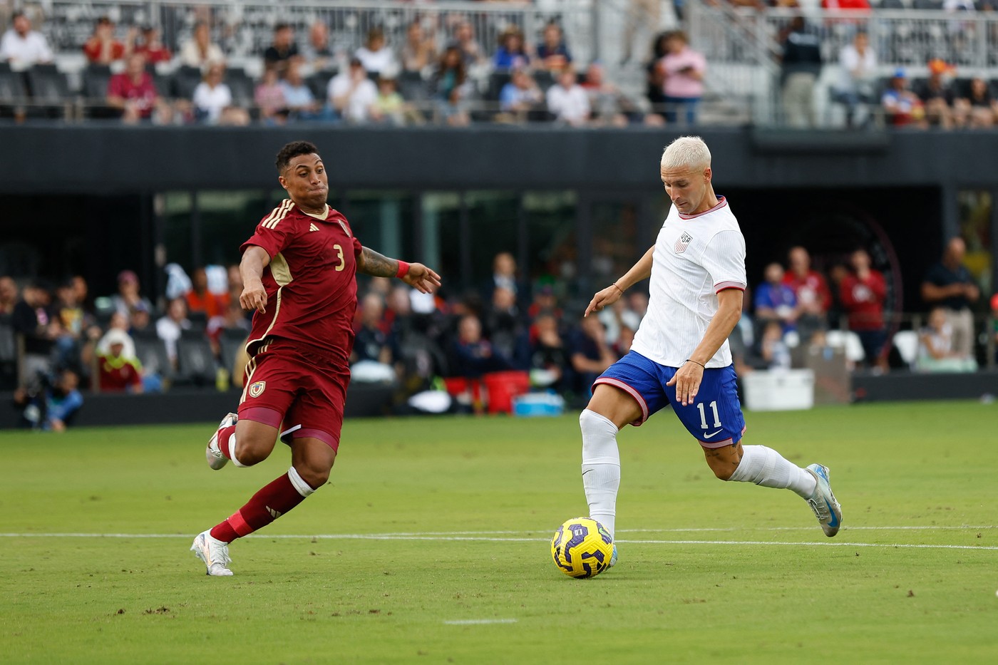 US forward #11 Matko Miljevic shoots on goal as Venezuelan defender #3 Anthony Graterol tries to block the shot during the USA against Venezuela international friendly at Chase Stadium in Fort Lauderdale, Florida, on January 18, 2025.,Image: 955105372, License: Rights-managed, Restrictions: , Model Release: no, Credit line: Chris Arjoon / AFP / Profimedia