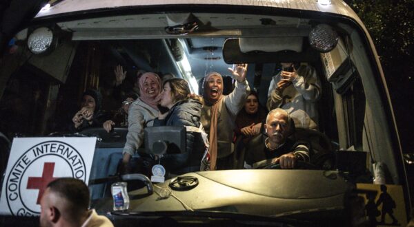 Palestinian freed prisoners wave to the crowd from a Red Cross bus that drove them out of the Israeli Ofer military prison in the occupied West Bank, as they arrive in Beitunia, on the outskirts of Ramallah, in the early hours of January 20, 2025. Crowds cheered, chanted and honked car horns as two buses carrying some 90 Palestinian prisoners freed from an Israeli jail as part of the Gaza ceasefire deal that began on January 19 and saw three Israeli hostages freed by Hamas in the Gaza Strip.,Image: 955502244, License: Rights-managed, Restrictions: , Model Release: no, Credit line: JOHN WESSELS / AFP / Profimedia