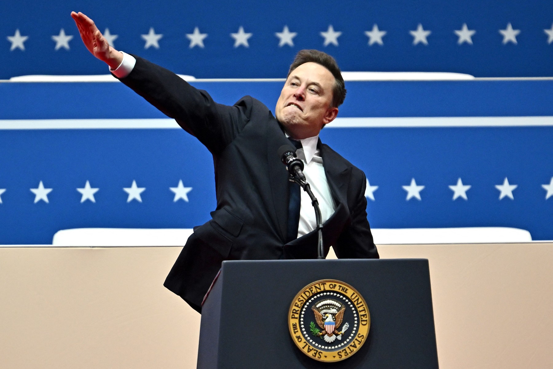 (FILES) Tesla and SpaceX CEO Elon Musk gestures as he speaks during the inaugural parade inside Capitol One Arena, in Washington, DC, on January 20, 2025. Musk's hand gestures at an inauguration event for US President Donald Trump, which quickly drew comparisons to Nazi salutes, appear to have resonated in some far-right extremist spaces online. Several neo-Nazi leaders have shared clips of the viral moment from Musk's Monday speech, in which the billionaire brought his hand to his chest and extended it straight out, twice, before saying: "My heart goes out to you.",Image: 956197585, License: Rights-managed, Restrictions: , Model Release: no, Credit line: ANGELA WEISS / AFP / Profimedia